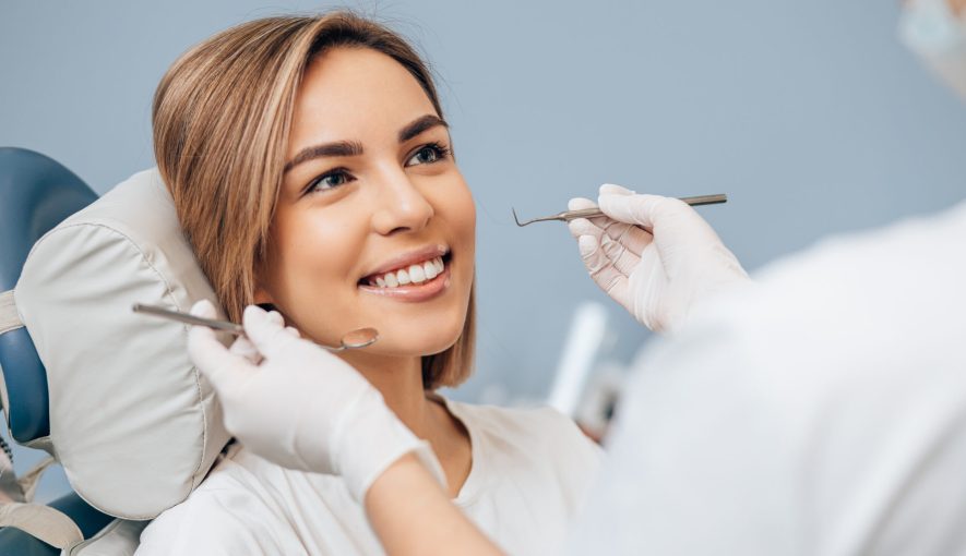 Beautiful smiling Turkish woman is holding an invisalign bracer, includes copy space